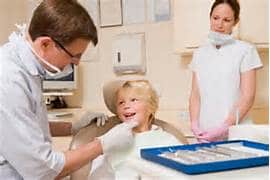 Image of a dental team with a young patient. Do they need an associate?